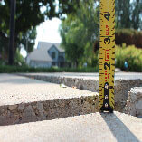 Uneven driveway shown before PolyLift concrete lifting.